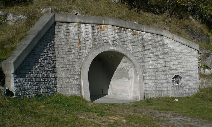 The entrance to a hydroelectric pressure tunnel from an alpine reservoir in Switzerland.