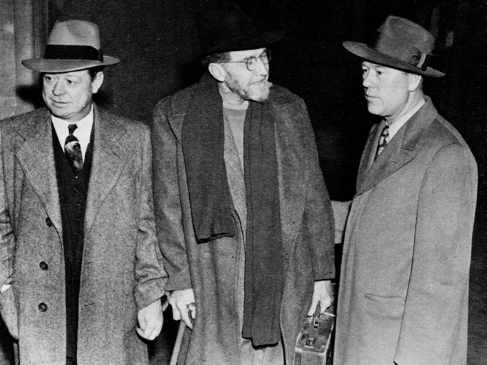 Ezra Pound in the custody of two U.S. Marshals upon his arrival in the USA in 1945.