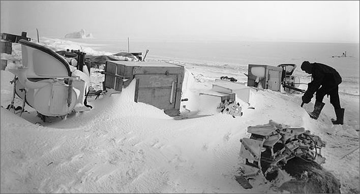 Terra Nova expedition: Bernard Day digging out a snowed up motor tractor.