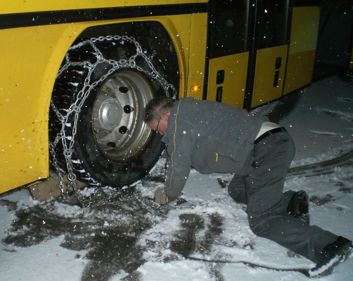 Putting the chains on the PostAuto with the onset of snow.